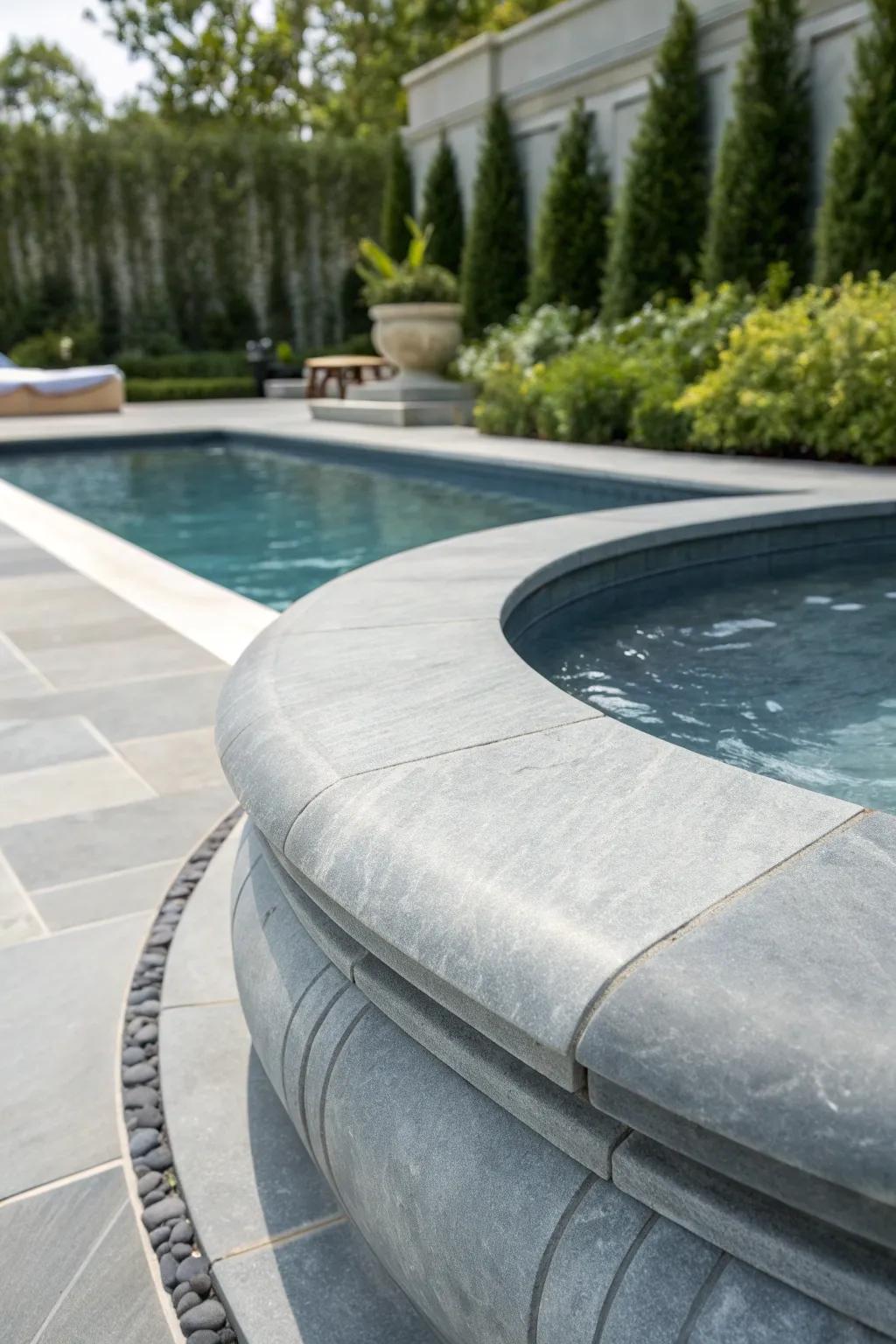 Embrace the elegance of slate gray pool coping for a seamless, modern garden oasis.