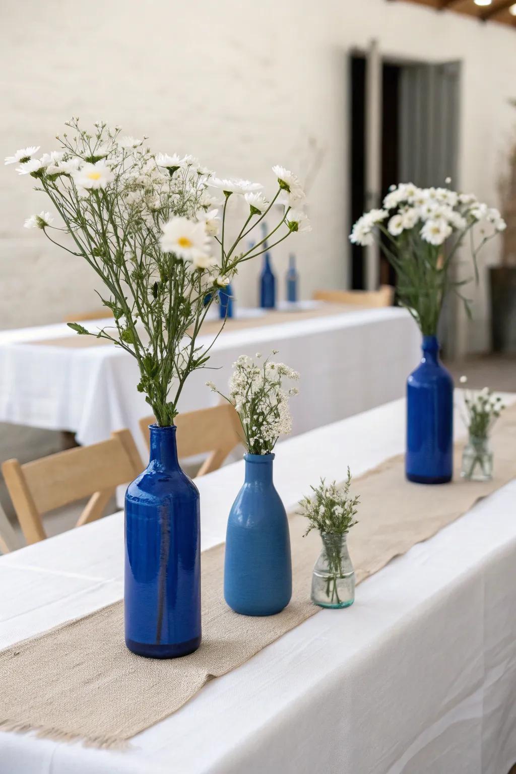 Simple royal blue vases with single-type flowers offer understated sophistication.