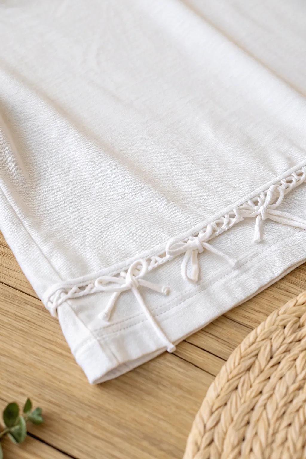 Elevate your tee with a chic knotted fringe finish—where simplicity meets style.