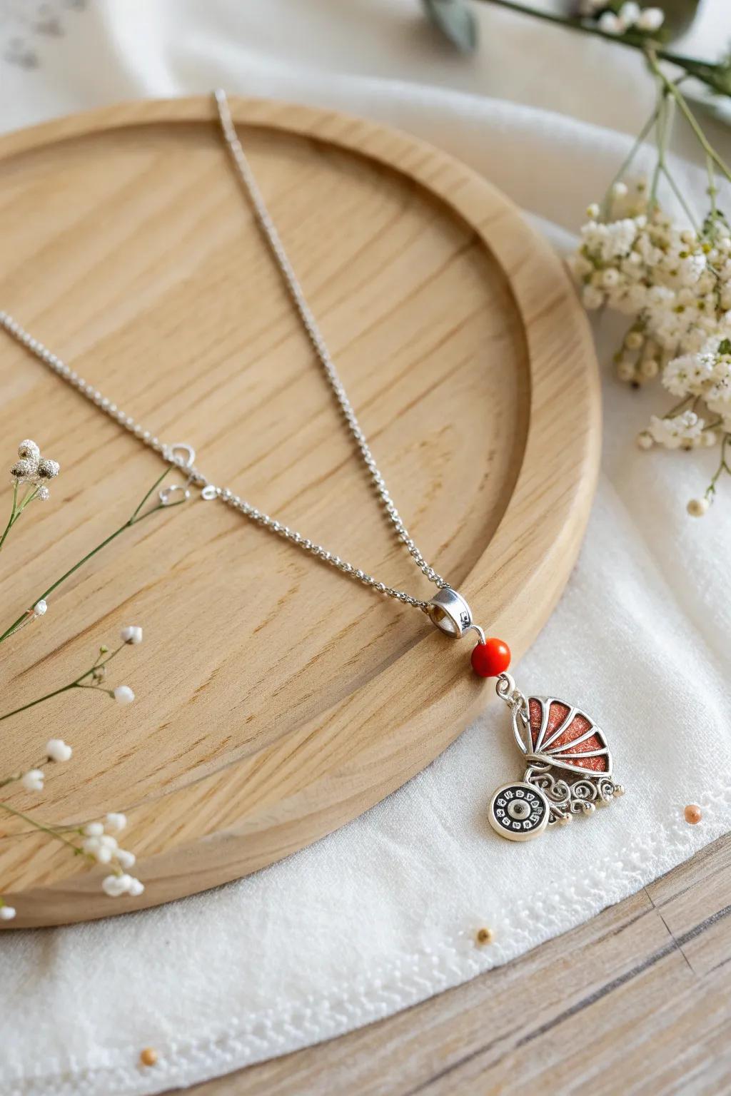 A timeless keepsake: This beautifully crafted charm necklace captures the essence of cherished baby shower memories with elegance and simplicity.
