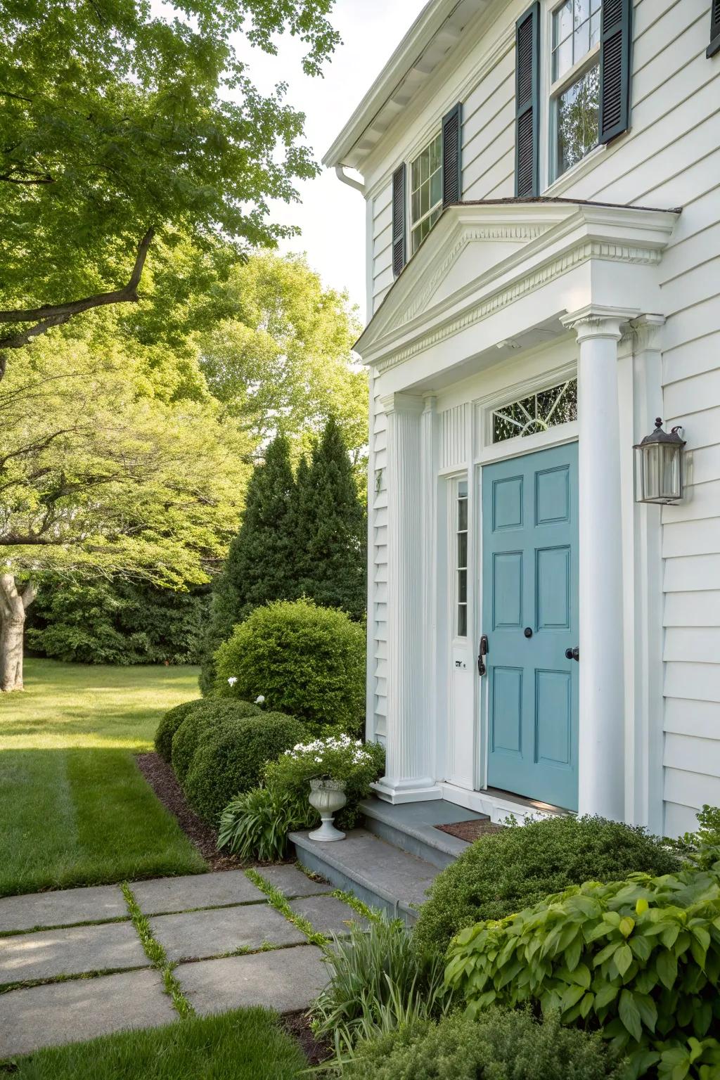 A soft blue door offers a unique and refreshing twist on traditional colonial colors.