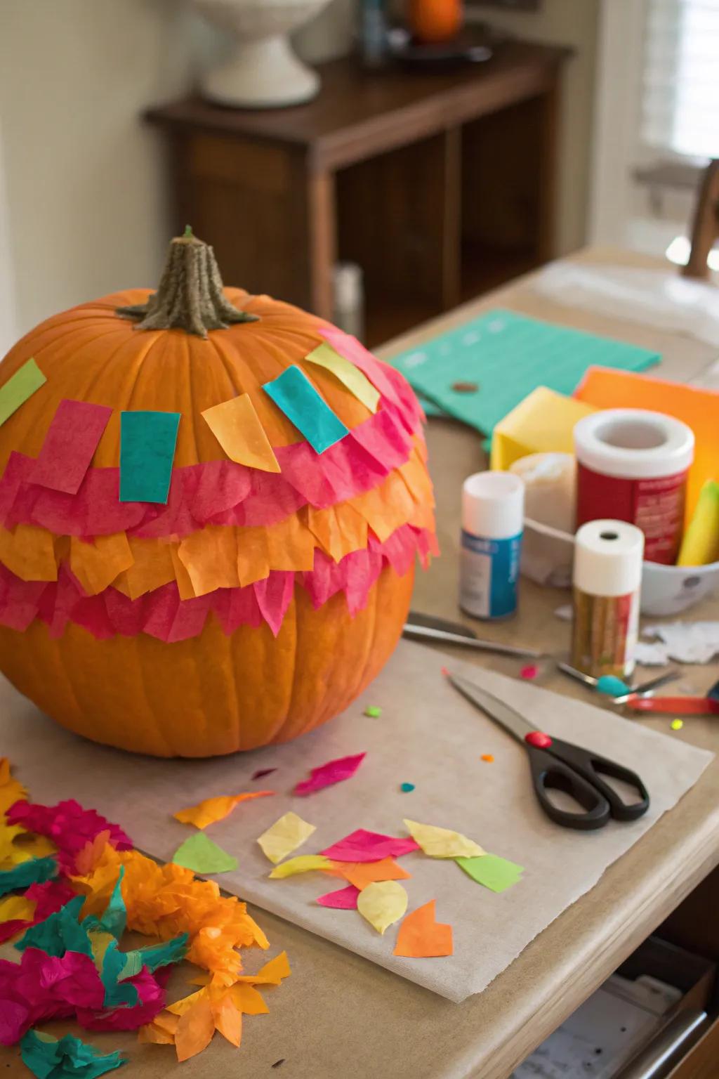 A colorful tissue paper-decorated pumpkin.