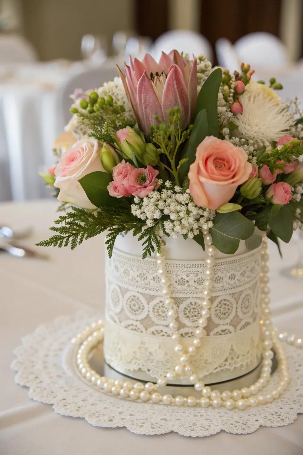 An elegant centerpiece with lace and pearls.