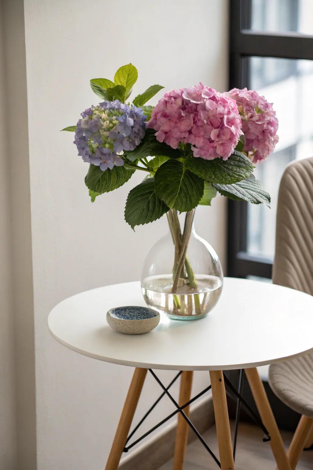 A single hydrangea in a snifter vase offers understated beauty.