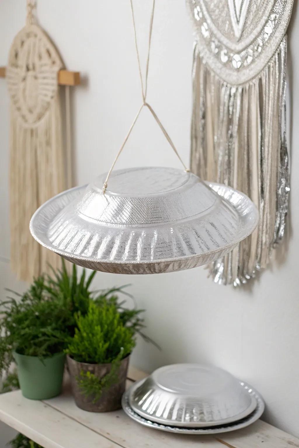 Craft your own cosmic charm with these elegant paper plate UFOs!