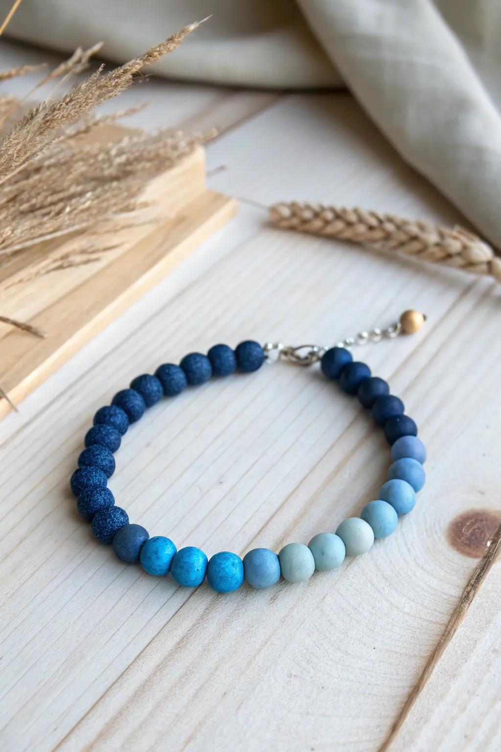 Embrace the serene beauty of ombre blues with this handcrafted clay bead bracelet.
