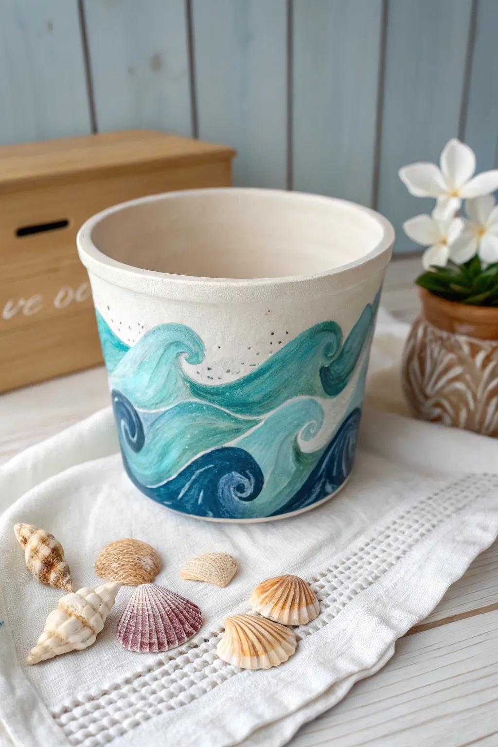 Bring the soothing essence of the ocean into your home with this beautifully crafted ocean waves and seashells painted pot.