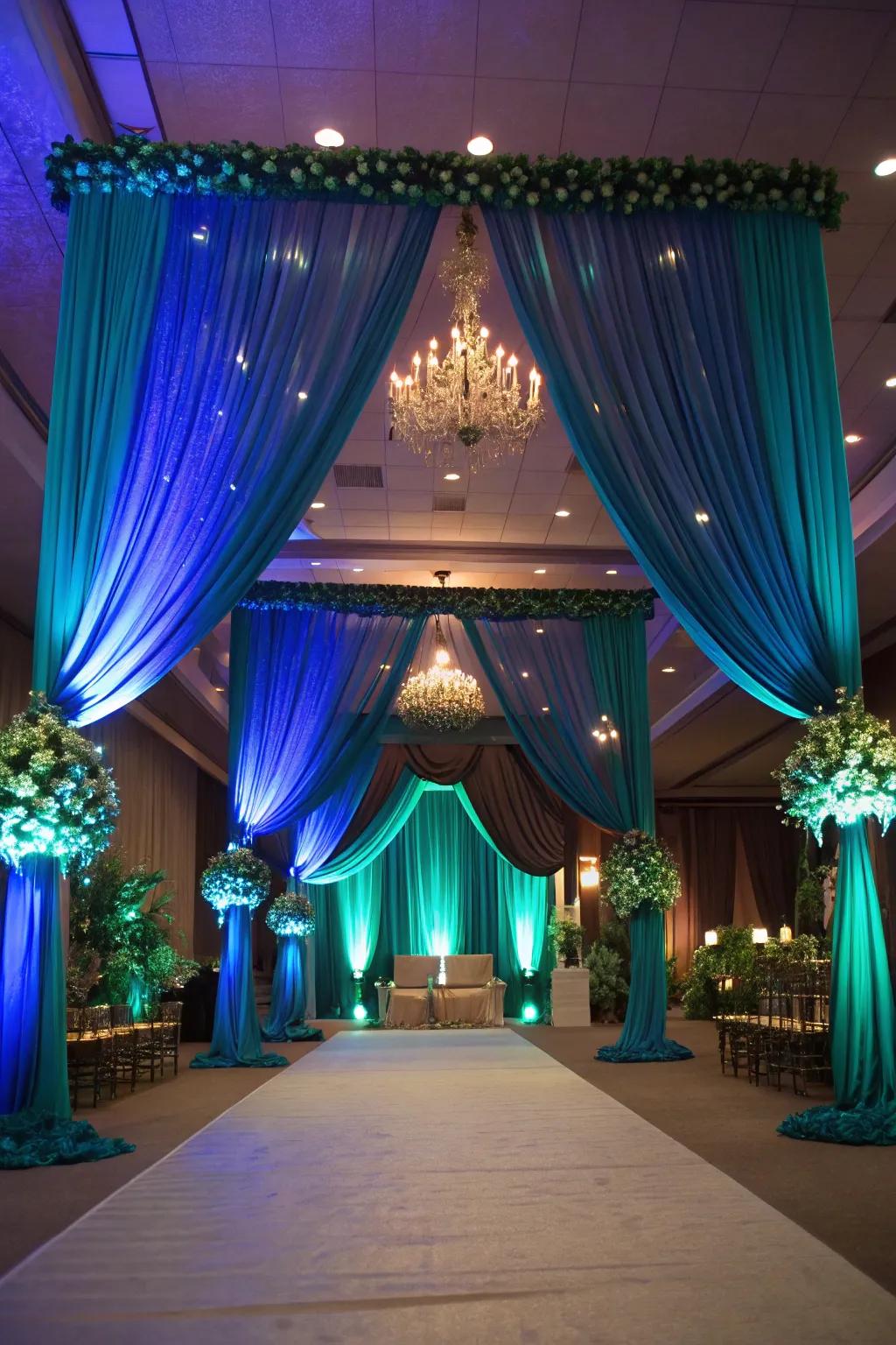 A venue transformed with dramatic drapery and lighting in peacock hues.