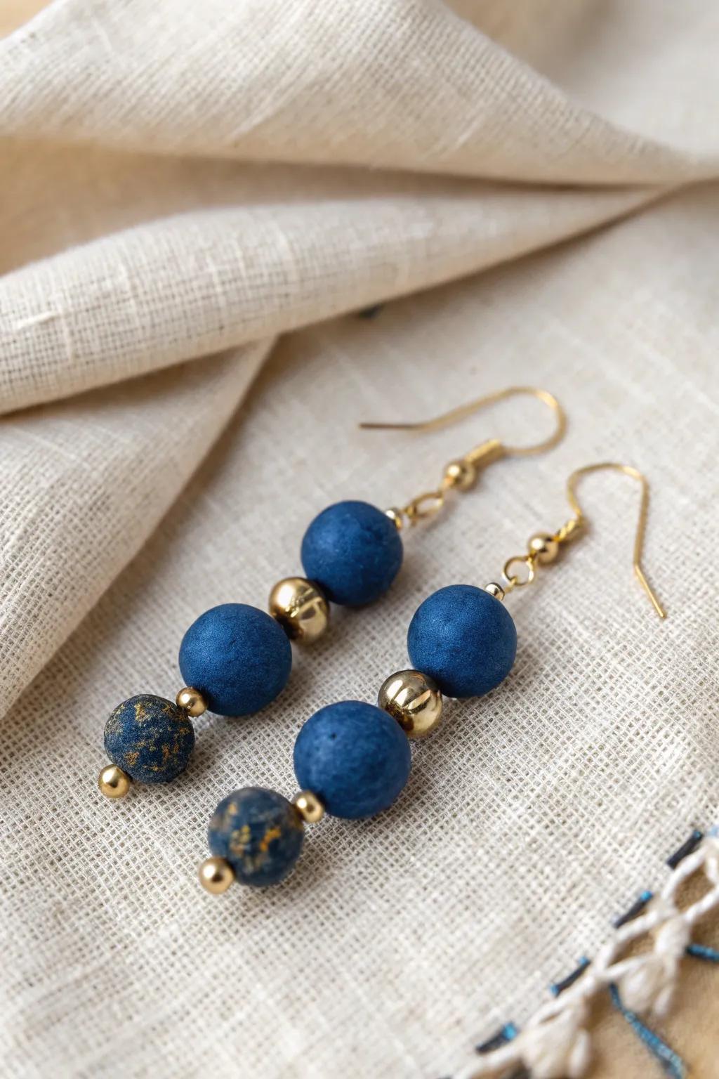 Elevate your style with these stunning clay bead earrings, where deep blue meets golden glam!