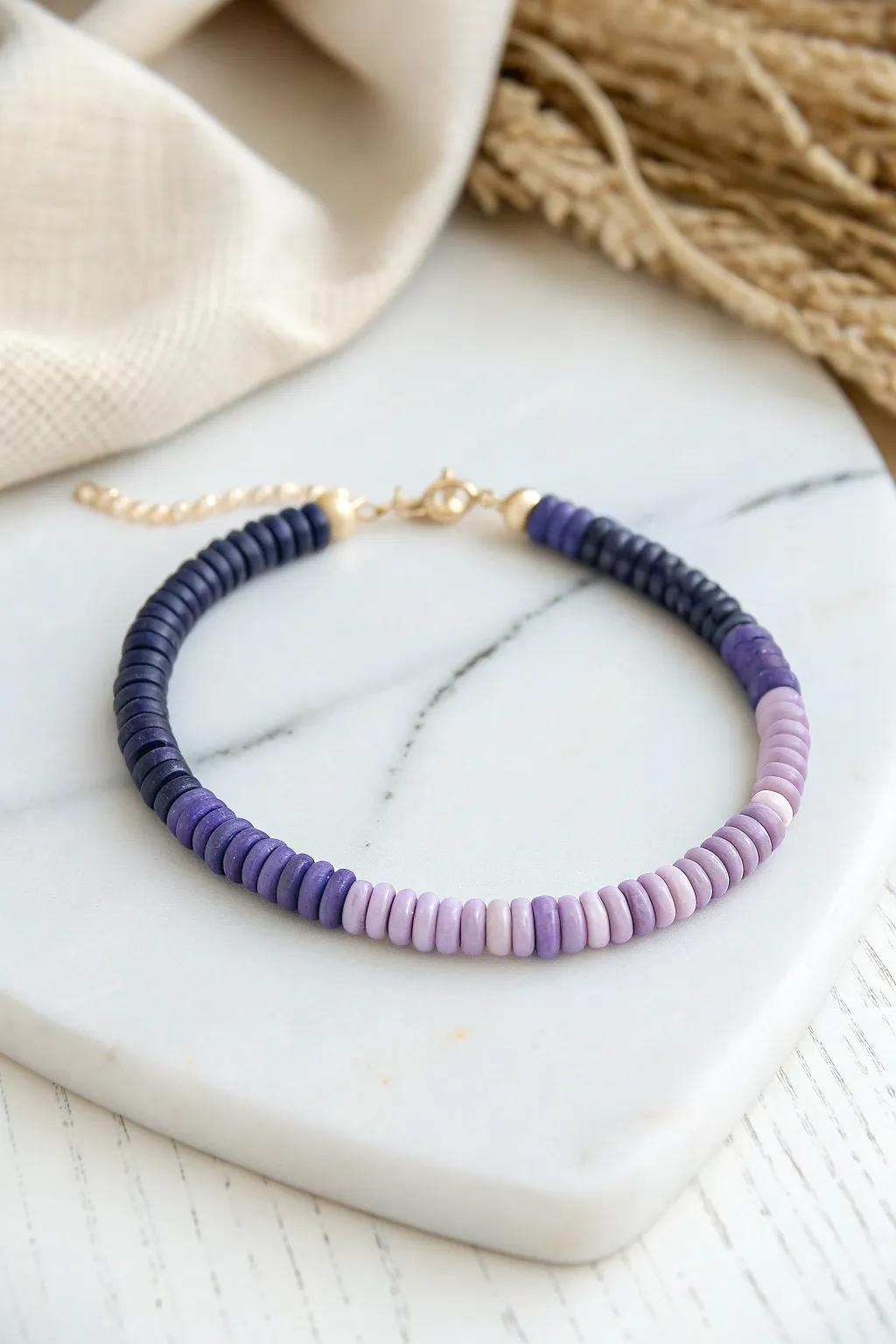 Embrace the serene beauty of ombre with this handcrafted disc bead bracelet.
